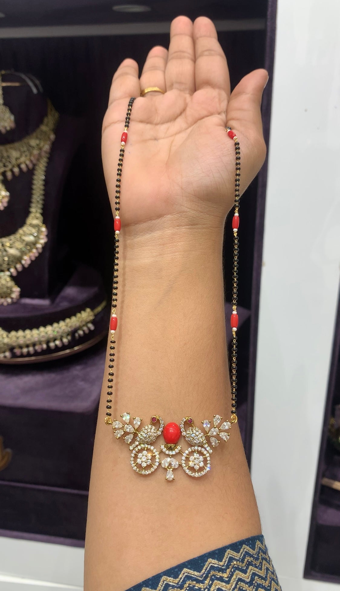 Beautiful peacock coral stone locket with black beads