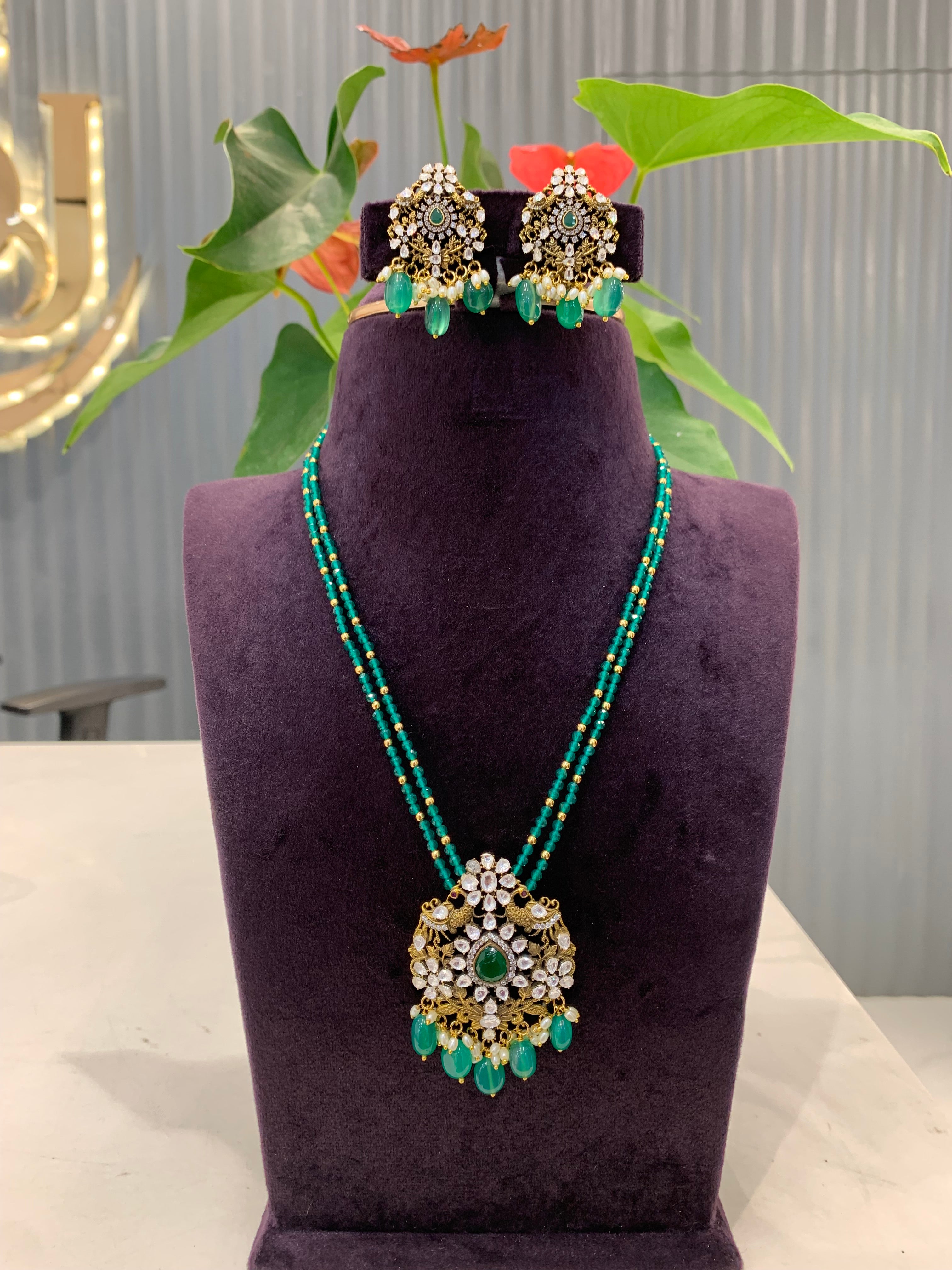Beautiful peacock pendent set with Green crystals Danda